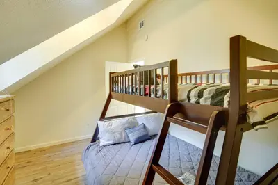 two bunk beds in a room with a staircase at All-Season Crestline Escape - 2 Mi to Lake! in Crestline
