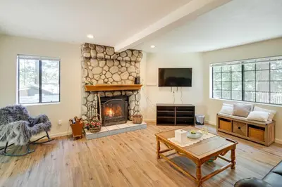 a living room with a fireplace and a tv at All-Season Crestline Escape - 2 Mi to Lake! in Crestline