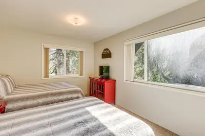 a bedroom with two beds and a window at Spacious Retreat 13 Mi to Snow Valley Mtn Resort! in Lake Arrowhead