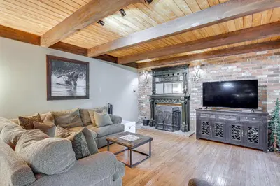 a living room with a couch and a fireplace at Spacious Retreat 13 Mi to Snow Valley Mtn Resort! in Lake Arrowhead