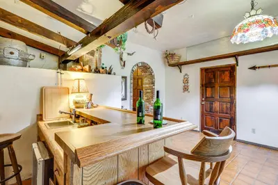 a kitchen with a counter with two bottles of wine at Spacious Retreat 13 Mi to Snow Valley Mtn Resort! in Lake Arrowhead
