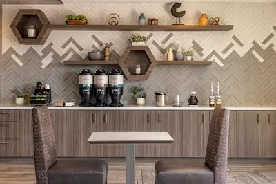 a bar with two chairs and a table in a restaurant at Residence Inn by Marriott Los Angeles Redondo Beach in Redondo Beach