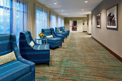 a waiting room with blue chairs in a hospital at Residence Inn by Marriott Los Angeles Redondo Beach in Redondo Beach
