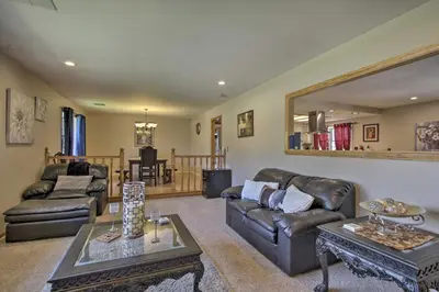 a living room with leather furniture and a mirror at Spacious Lancaster Family Ranch - BBQ and Patio in Lancaster