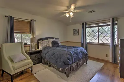 a bedroom with a bed and a chair and window at Spacious Lancaster Family Ranch - BBQ and Patio in Lancaster