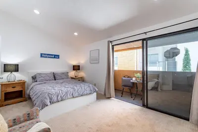 a bedroom with a bed and a sliding glass door at Franklin Hollywood Bowl Loft in Los Angeles