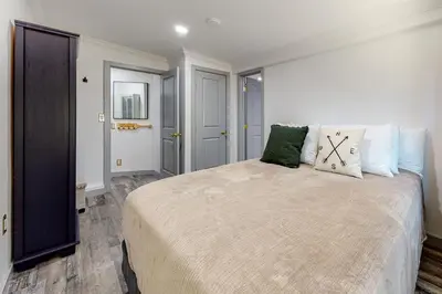 a bedroom with a large bed with two pillows on it at Top Town Retreat in Crestline