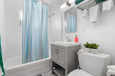 a bathroom with a sink and a toilet and a shower at The Green Haven, 1 Minute Walk to the Beach and Restaurants, King Beds, Beach Amenities in Ventura