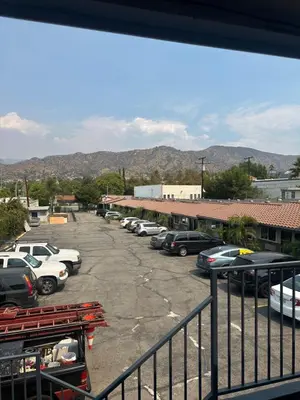 a parking lot with a bunch of cars parked at Stardust inn in Azusa