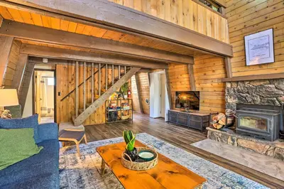 a living room with a couch and a fireplace at Pet-Friendly Cottage, Walk From Big Bear Village! in Big Bear Lake