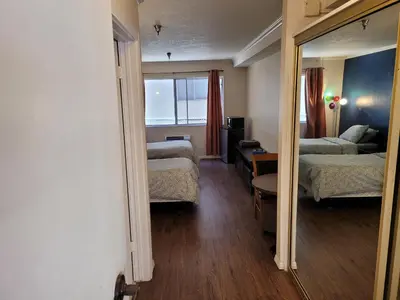 a hotel room with two beds and a mirror at (A11) Lovely Double Bed Unit in Los Angeles