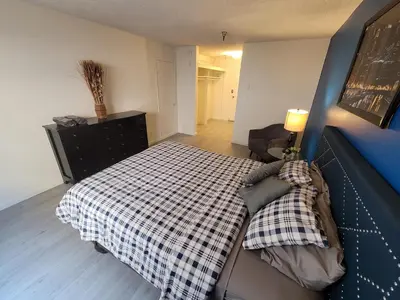 a bedroom with a bed with a checkered blanket at (A13) Cozy 1 Bedroom Studio with Private Bath in Los Angeles