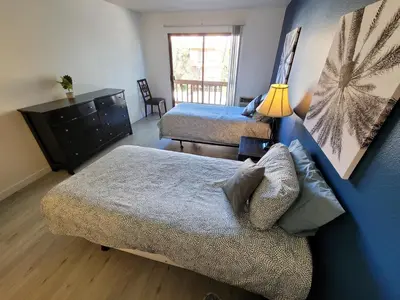 a bedroom with two beds and a couch and a dresser at (B02) Cozy Double Bed Suite in Los Angeles