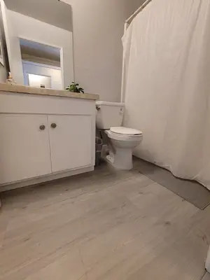 a bathroom with a toilet and a sink and a mirror at (B02) Cozy Double Bed Suite in Los Angeles