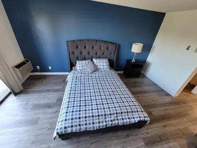 a bedroom with a bed with a checkered blanket at (B27) Cozy & Serene Private LA Studio in Los Angeles