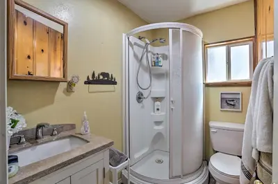 a bathroom with a shower and a toilet and a sink at Big Bear Cabin Close to Lake, Trails and Village! in Big Bear Lake