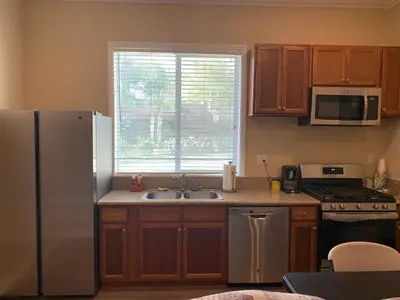 a kitchen with a sink and a refrigerator at LuxHome Suites in Mansion in Riverside