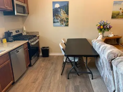 a small kitchen with a table and a couch at LuxHome Suites in Mansion in Riverside