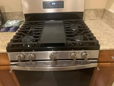 a stove top oven sitting in a kitchen at LuxHome Suites in Mansion in Riverside