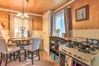 a kitchen with a table and a stove and a dining room at Cozy Crestline Cabin, Close to Lakes, Parks! in Crestline