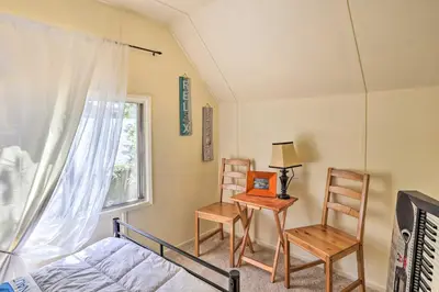 a bedroom with a bed and a table and chairs at Cozy Crestline Cabin, Close to Lakes, Parks! in Crestline