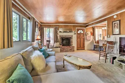 a living room with a couch and a fireplace at Cozy Crestline Cabin, Close to Lakes, Parks! in Crestline