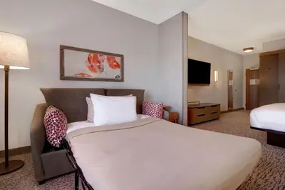a hotel room with a large bed and a television at Fairfield Inn & Suites Lancaster Palmdale in Lancaster