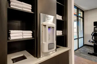 a towel dispenser in a bathroom with towels at Fairfield Inn & Suites Lancaster Palmdale in Lancaster