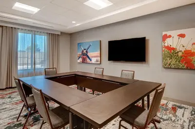 a conference room with a table and a flat screen tv at Fairfield Inn & Suites Lancaster Palmdale in Lancaster