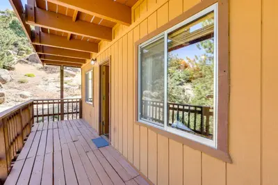 a porch of a house with a large window at Snow Valley Hideaway Arrowbear Lake Retreat in Arrowbear Lake