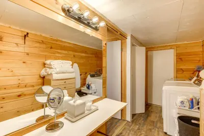 a bathroom with a sink and a washer and dryer at Snow Valley Hideaway Arrowbear Lake Retreat in Arrowbear Lake