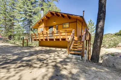 a small yellow cabin with a tree at Snow Valley Hideaway Arrowbear Lake Retreat in Arrowbear Lake