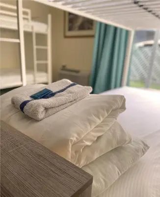 a bed with pillows and a towel on top of it at Bposhtels Anaheim in Anaheim