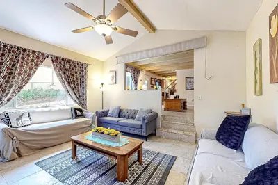 a living room with two couches and a table at Treelands Lodge in Crestline