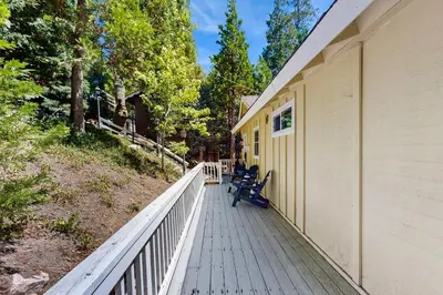 a porch of a house with two benches on it at Treetop Cottage in Running Springs