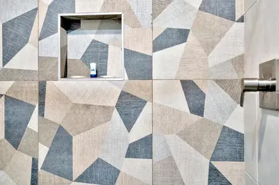 a bathroom with a geometric tile wall with a mirror at Royal Hawaiian Inn - Mid City, Los Angeles in Los Angeles