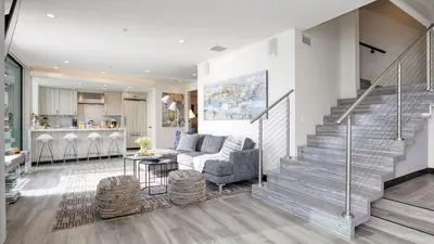 a living room with a staircase and a kitchen at Matador by AvantStay Ocean Front Malibu Pad w Rooftop Patio in Topanga