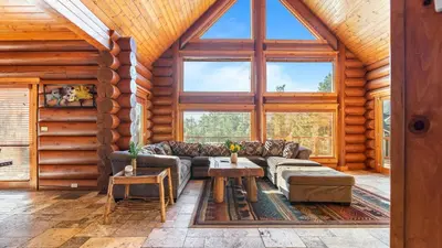 a living room with a couch and a table at 0.5mi to the Lake Deck w Views Poker Table Eagle Ridge Retreat by AvantStay in Big Bear Lake