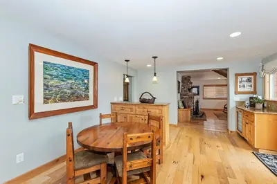 a kitchen and dining room with a wooden table at Lakefront Estate w Private Dock HotTub FirePit Lagunita Shores by AvantStay in Big Bear Lake