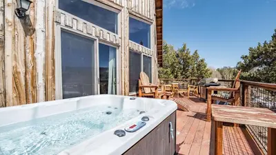 a hot tub on the deck of a house at Lakefront Lodge by AvantStay Direct Access to Big Bear Lake Hot Tub Views in Big Bear Lake