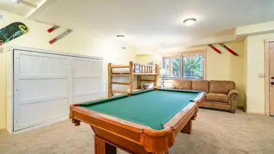 a living room with a pool table and a couch at Hot Tub Game Room Large Deck w Incredible View Penticton Lodge by AvantStay in Big Bear Lake