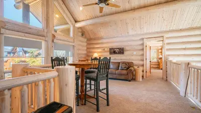 a dining room with a table and chairs in a cabin at Hot Tub Game Room Large Deck w Incredible View Penticton Lodge by AvantStay in Big Bear Lake