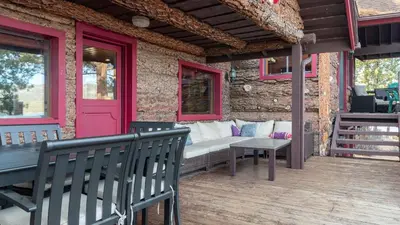 a porch with a bench and a pink door at Shoreline Lakehouse by AvantStay Majestic Lakefront Cabin w Hot Tub Fire Pit in Big Bear Lake