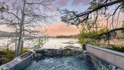 a plunge pool with a view of a lake at Shoreline Lakehouse by AvantStay Majestic Lakefront Cabin w Hot Tub Fire Pit in Big Bear Lake