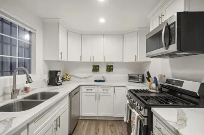 a white kitchen with a sink and a stove at The Avalon - 35 Percent Off March! in Los Angeles