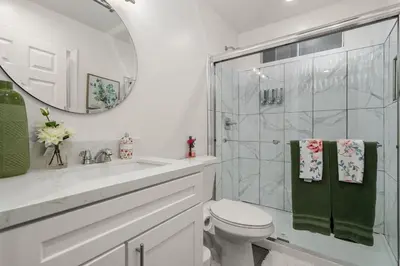 a bathroom with a toilet and a shower and a mirror at The Avalon - 35 Percent Off March! in Los Angeles
