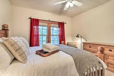 a bedroom with a bed with a dresser and a window at Spacious Lake Arrowhead Home with Putting Green in Lake Arrowhead