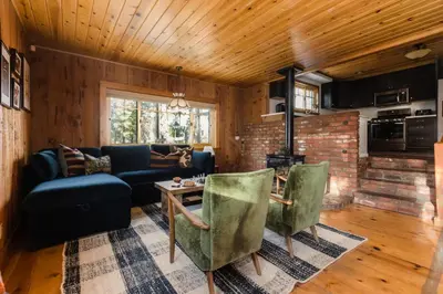 a living room with a couch and a table at Walk to the Lake Sand Volleyball Court Pool Table Deck Gambler by AvantStay in Big Bear Lake