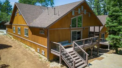 a large wooden house with a porch and a deck at Teddy by AvantStay Majestic Cabin in Big Bear w Balcony in Big Bear Lake