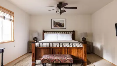 a bedroom with a bed and a ceiling fan at Jackhorn by AvantStay Close to Big Bear Marina and Village Hot Tub Foosball in Big Bear Lake